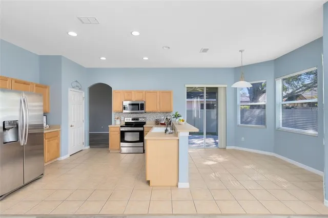 a kitchen with stainless steel appliances granite countertop a stove and a refrigerator