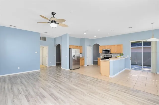 a view of kitchen with cabinets and refrigerator