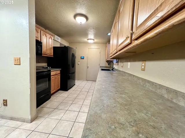 a view of a kitchen with an empty space and a window