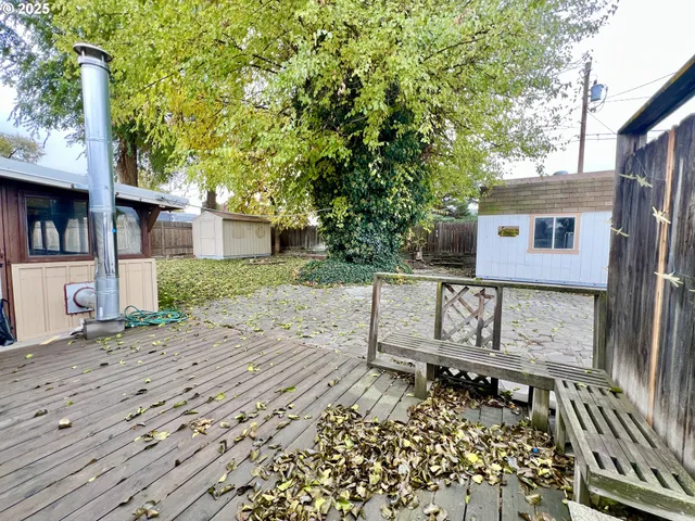 a view of a house with wooden fence