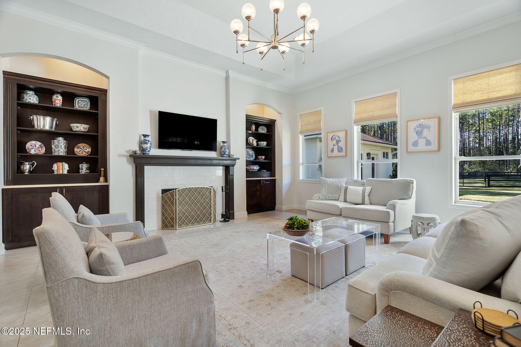 139 Foxcraft Street St. Augustine, FL 32092 - Photo 25 of 93 a living room with furniture a flat screen tv and a fireplace