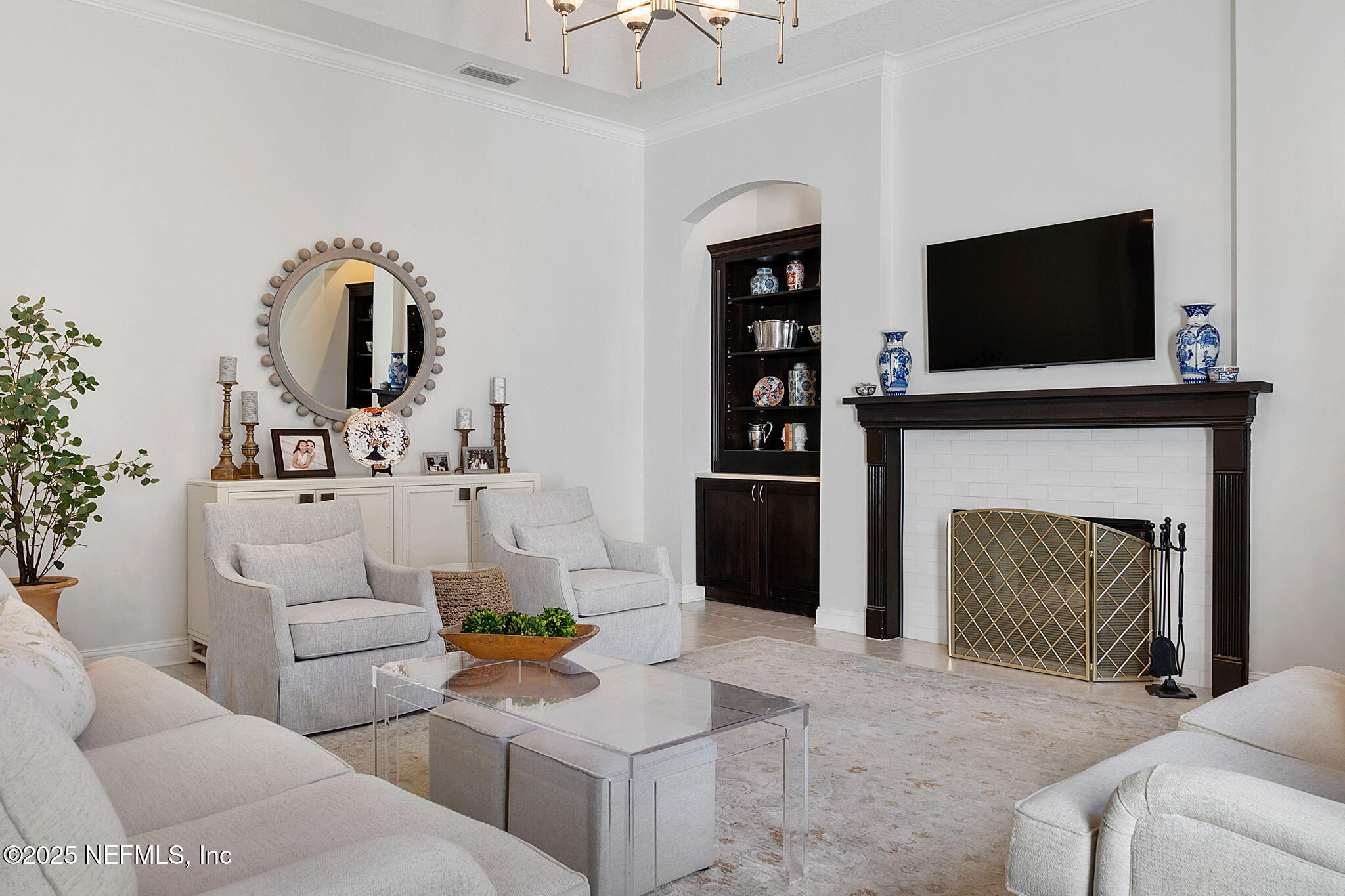 139 Foxcraft Street St. Augustine, FL 32092 - Photo 27 of 93 a living room with furniture a flat screen tv and a fireplace