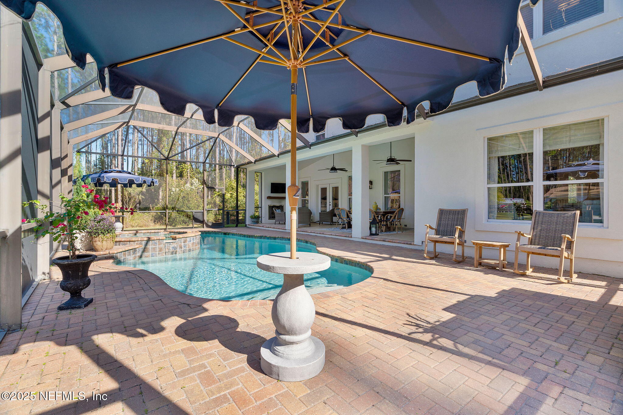 139 Foxcraft Street St. Augustine, FL 32092 - Photo 38 of 93 a view of a patio with a table and chairs under an umbrella