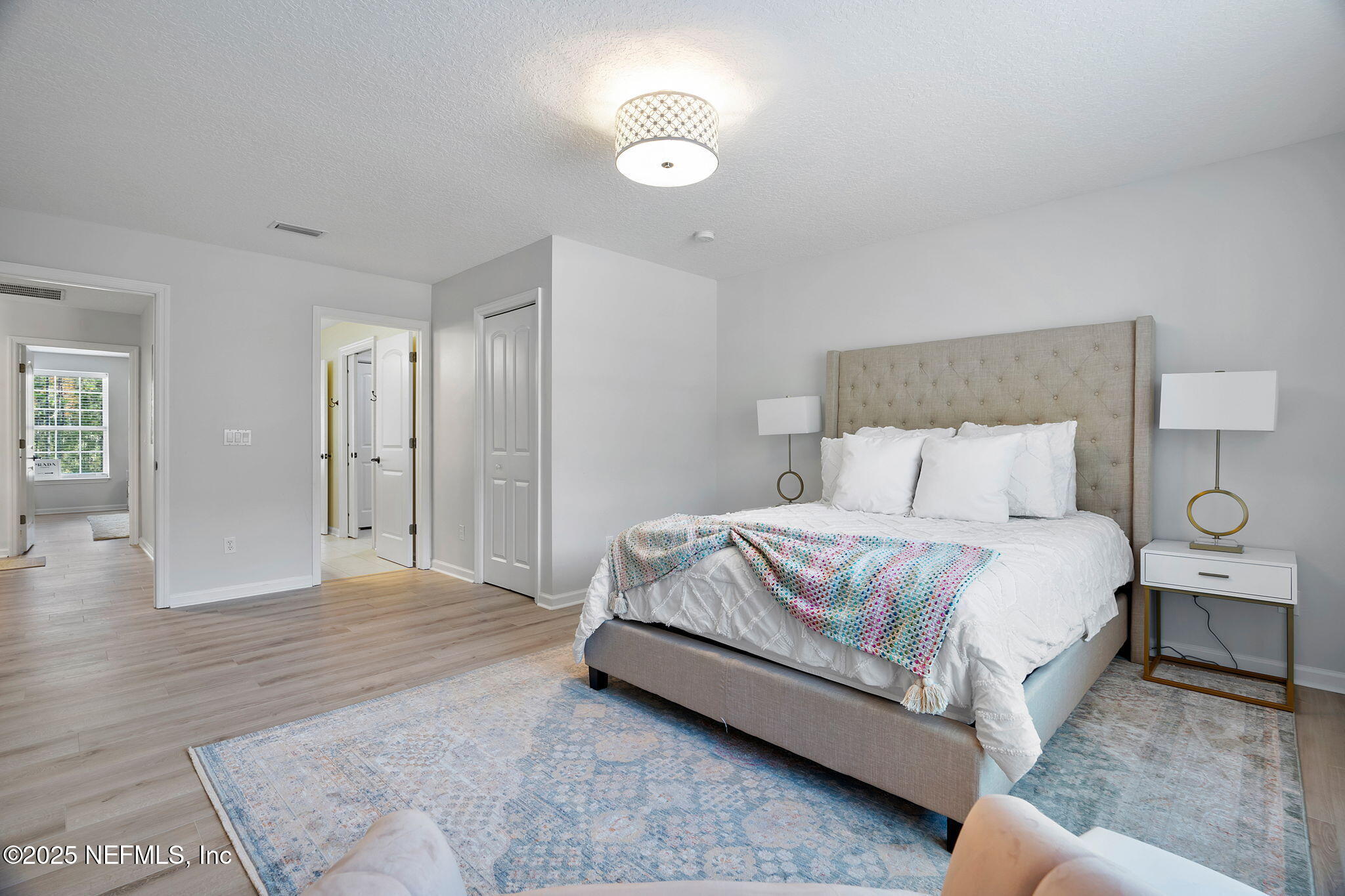 139 Foxcraft Street St. Augustine, FL 32092 - Photo 61 of 93 a spacious bedroom with a bed and a lamp