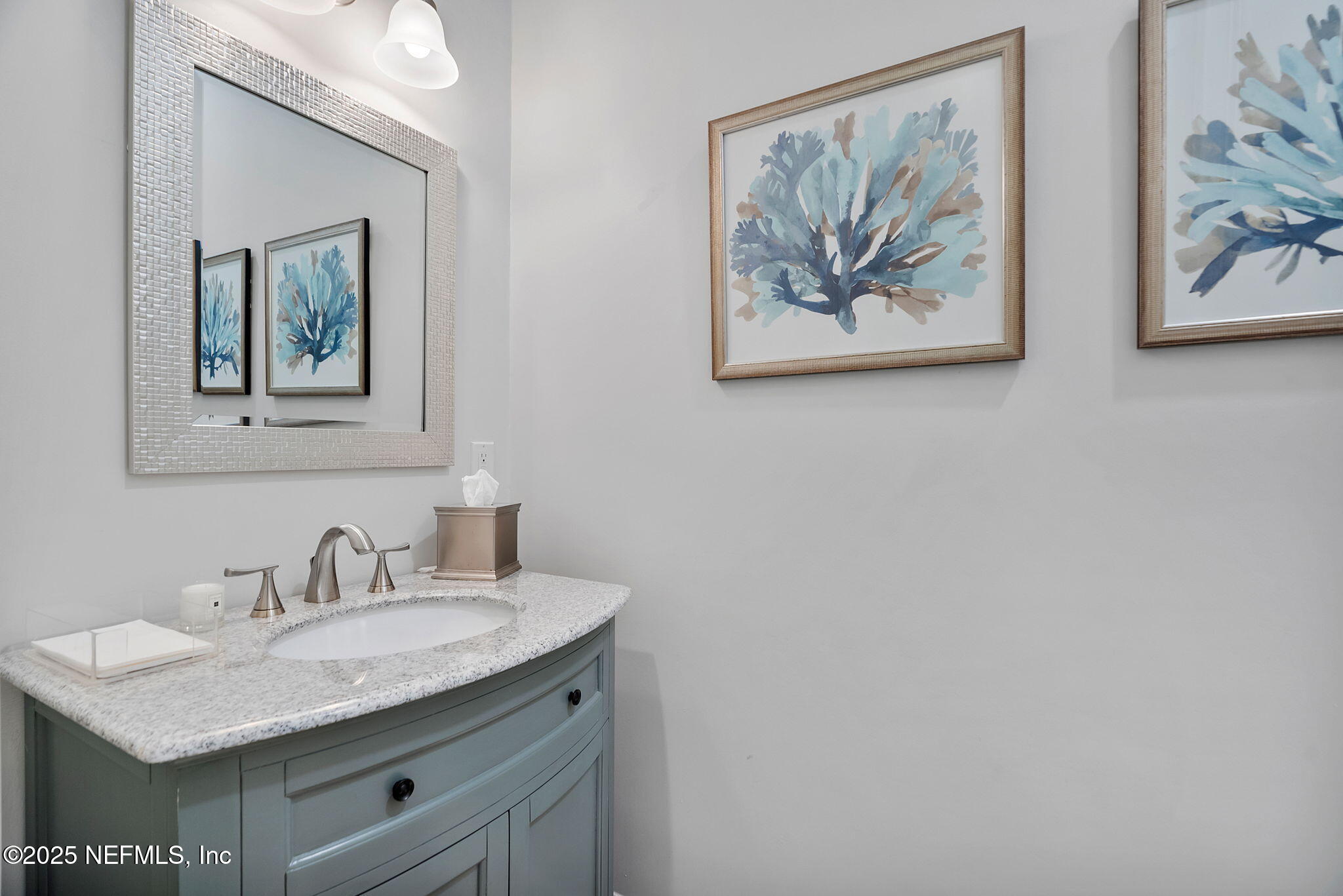 139 Foxcraft Street St. Augustine, FL 32092 - Photo 70 of 93 a bathroom with a granite countertop sink a mirror and a picture on the wall