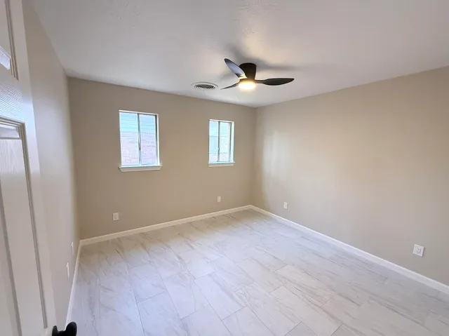 a view of an empty room with a window