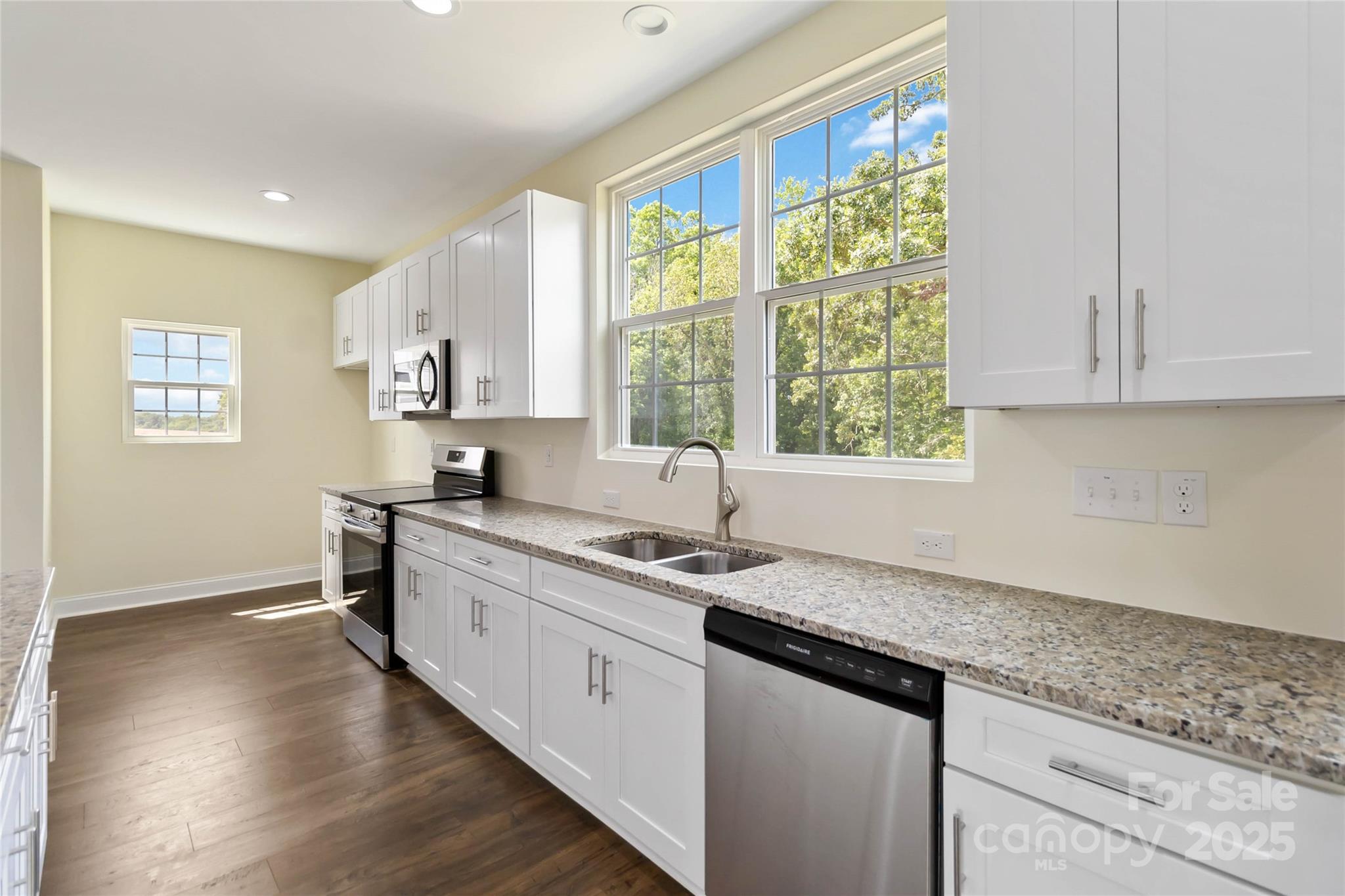 1034 Heath Helms Road Monroe, NC 28110 - Photo 12 of 30 a kitchen with a sink stove and cabinets