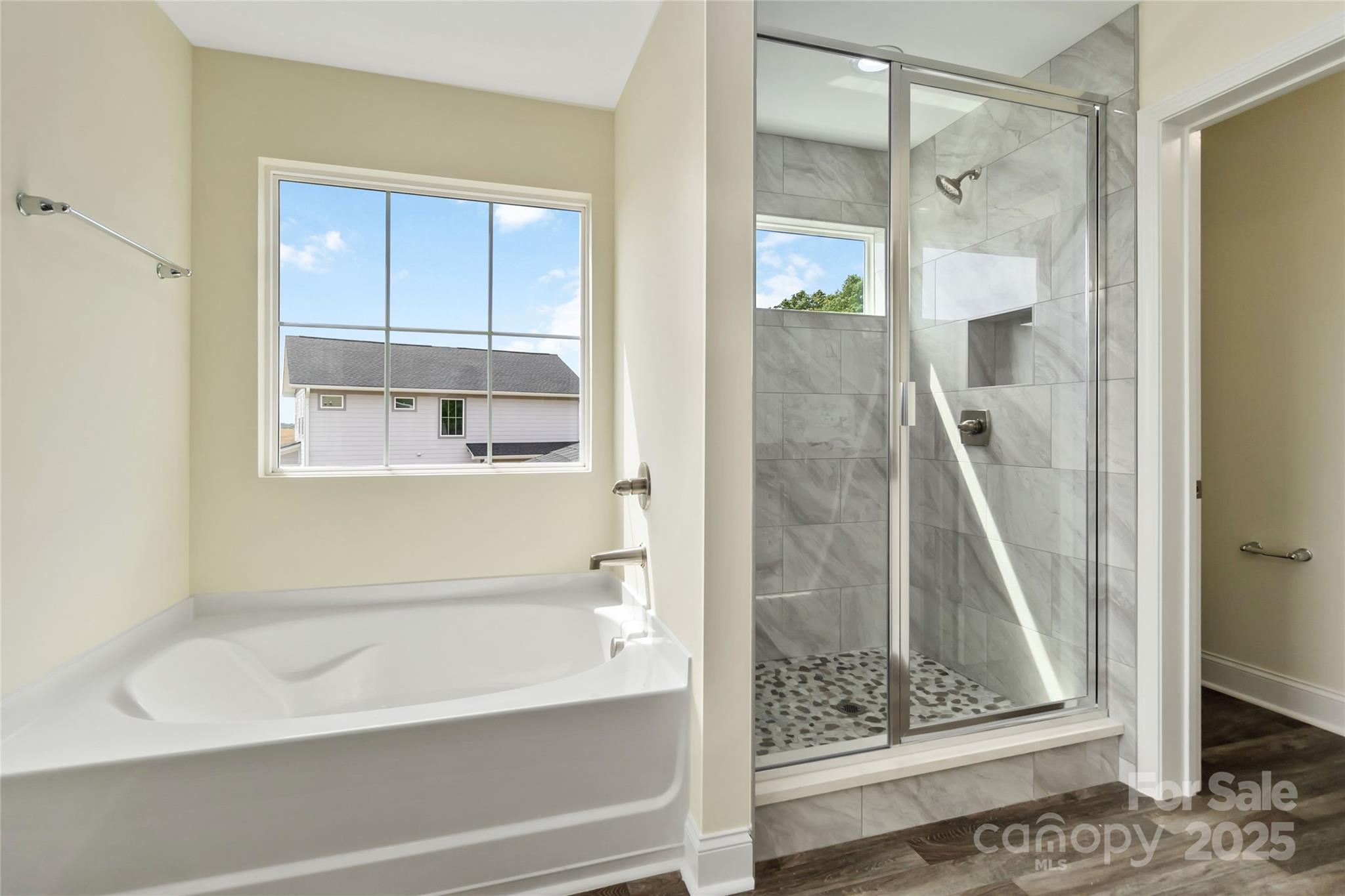 1034 Heath Helms Road Monroe, NC 28110 - Photo 18 of 30 a bathroom with a bathtub and a shower