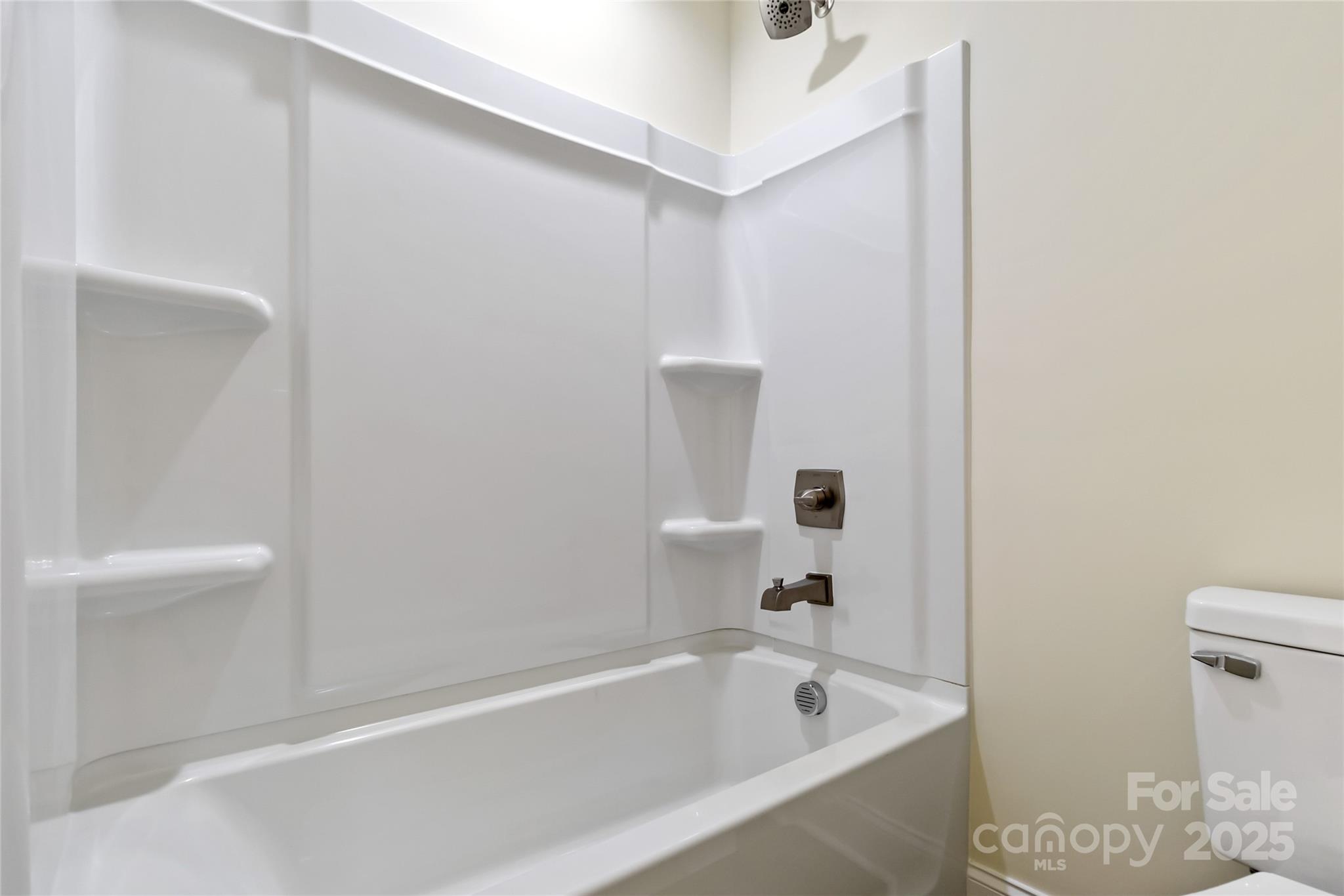 1034 Heath Helms Road Monroe, NC 28110 - Photo 25 of 30 a bathroom with a bathtub and a toilet