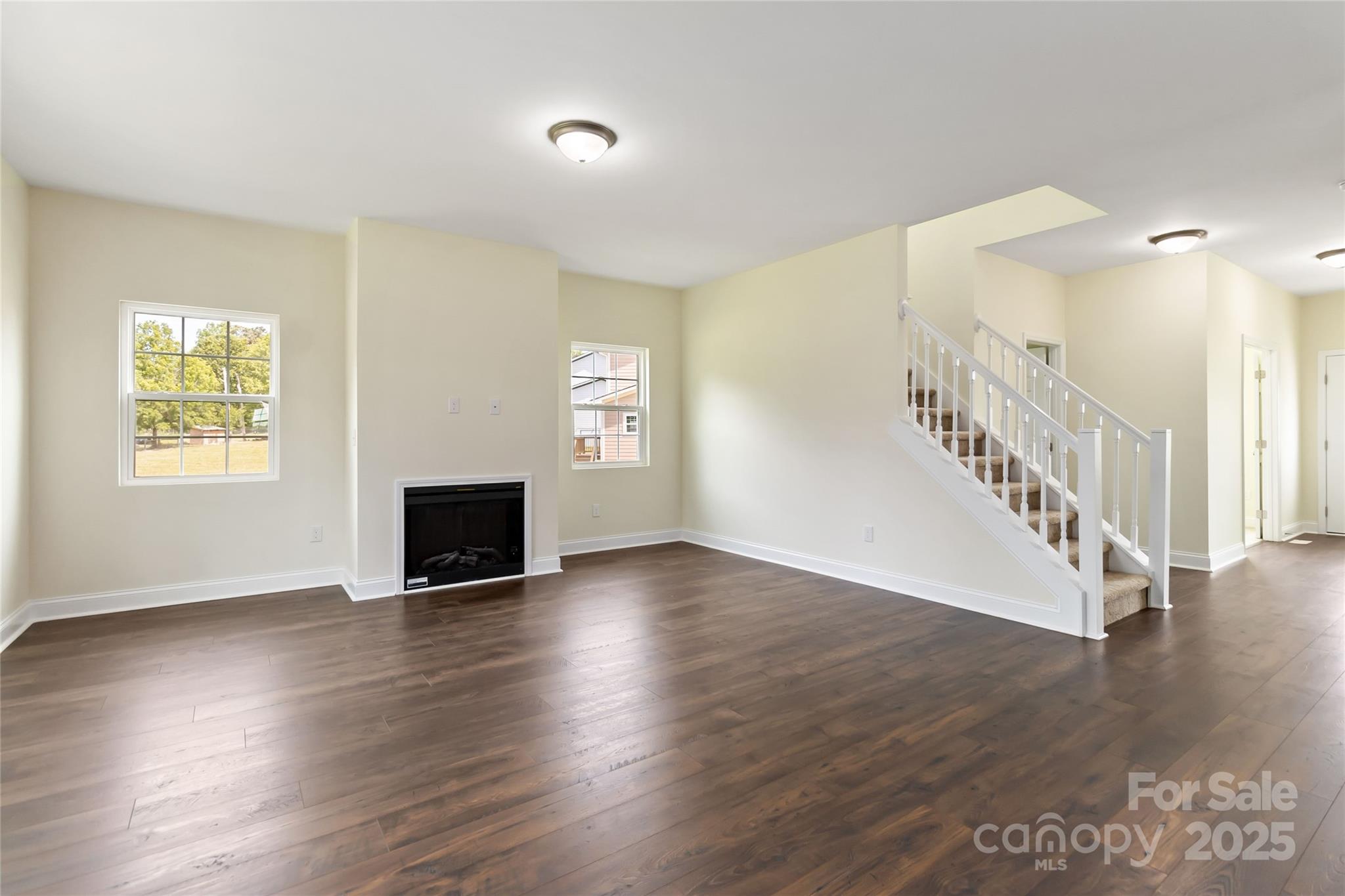 1034 Heath Helms Road Monroe, NC 28110 - Photo 8 of 30 a view of an empty room with wooden floor and a window