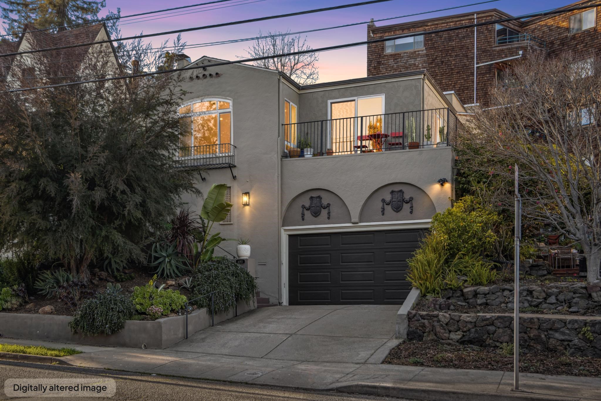 View of front facade featuring stucco siding, a balcony, concrete driveway, and a garage