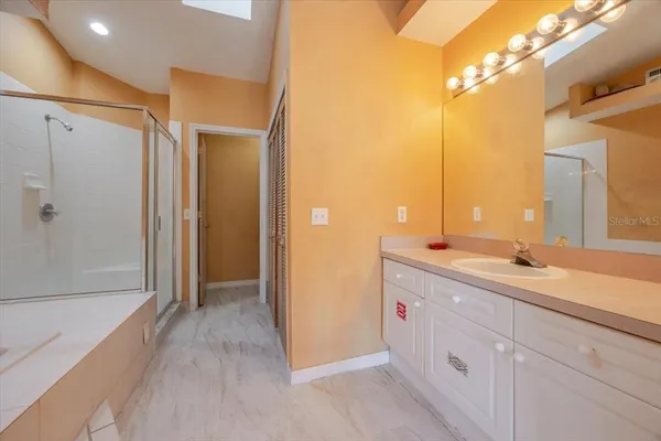 a spacious bathroom with a double vanity sink a mirror and a shower