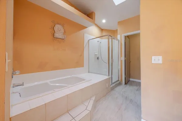a spacious bathroom with a bathtub and a shower
