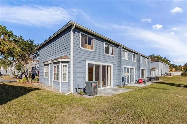 a view of a house with a yard and road