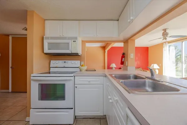 a kitchen with a sink and a refrigerator