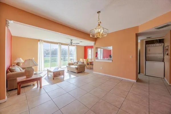 a living room with furniture and a chandelier