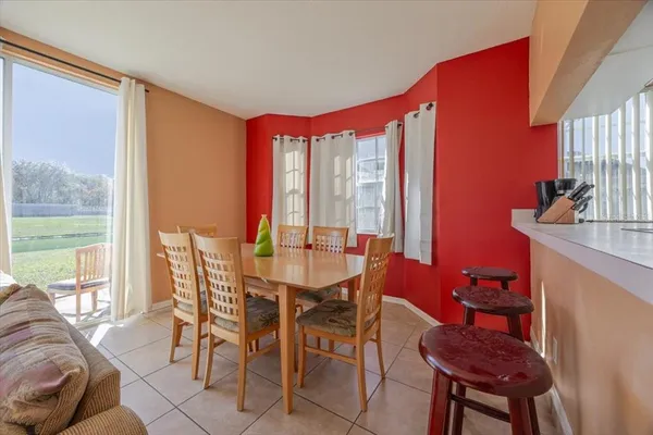 a dining room with furniture and a large window