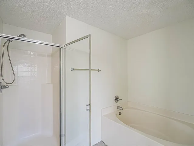 a white bath tub with a shower