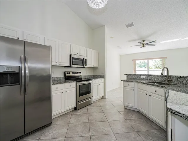 a kitchen with granite countertop a cabinets and steel stainless steel appliances