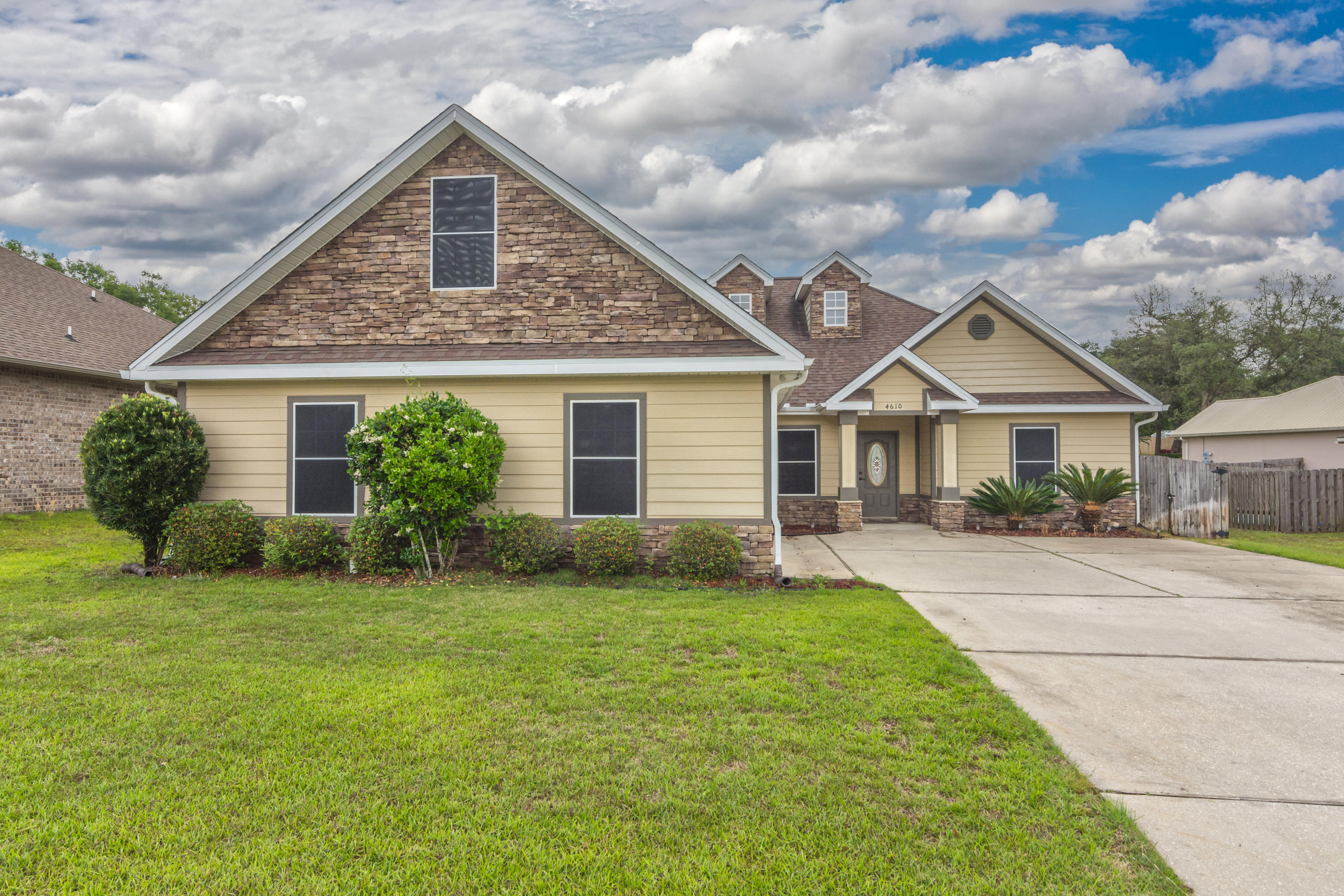 4610 Hermosa Road Crestview, FL 32539 - Photo 1 of 35 a front view of a house with a garden