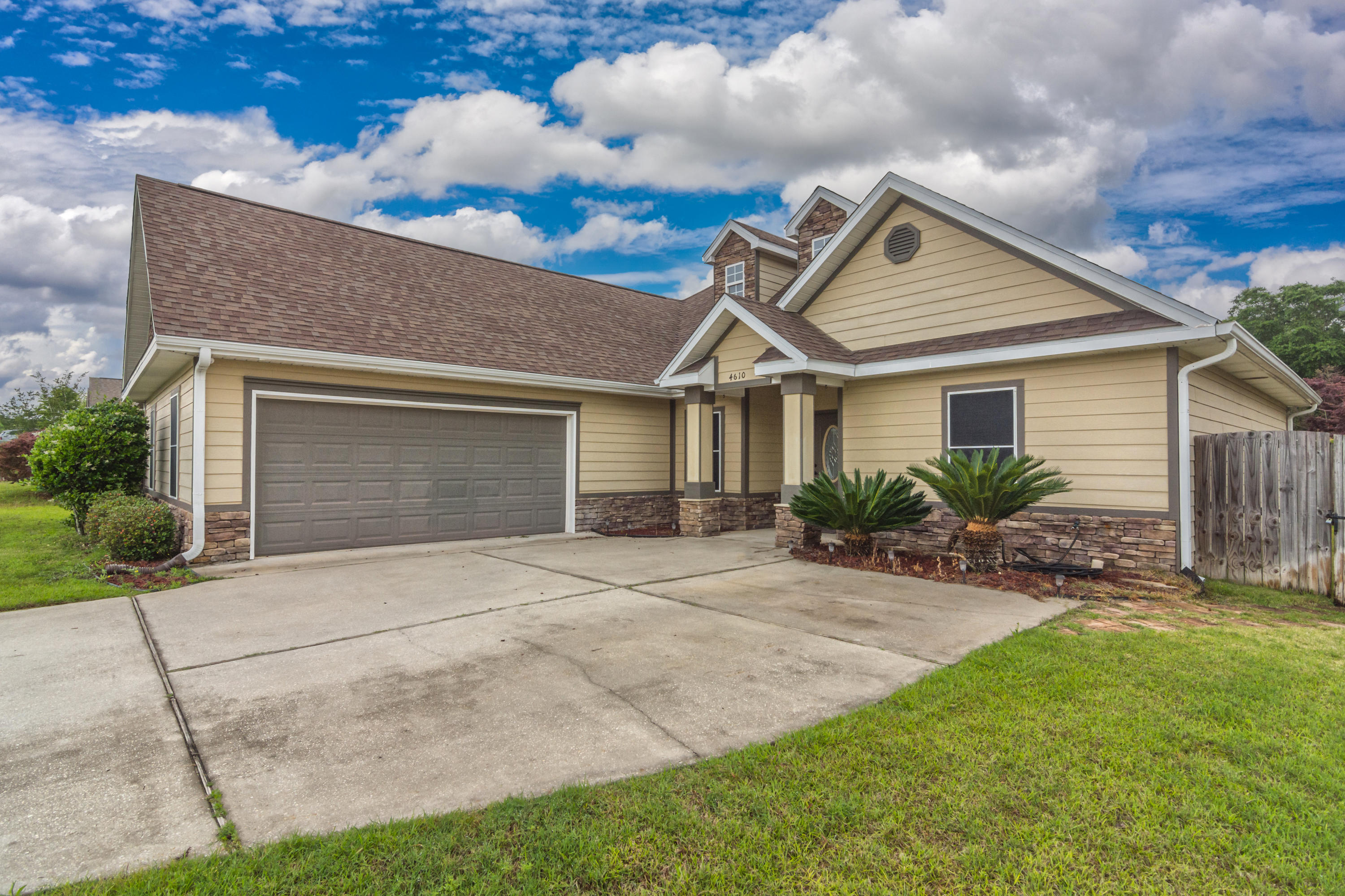 4610 Hermosa Road Crestview, FL 32539 - Photo 2 of 35 a front view of a house with a yard and garage