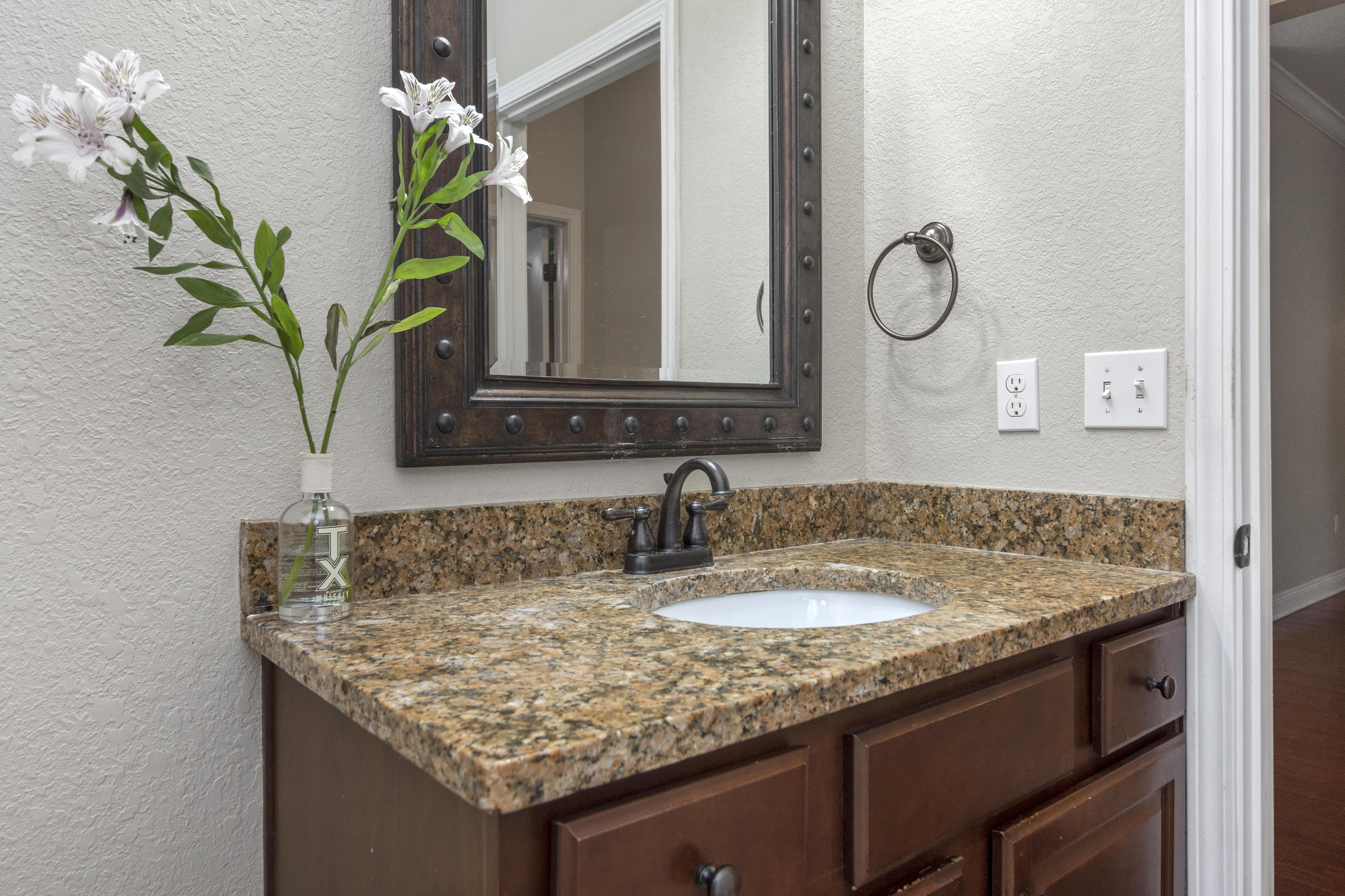 4610 Hermosa Road Crestview, FL 32539 - Photo 24 of 35 a bathroom with a granite countertop sink a vanity and a mirror