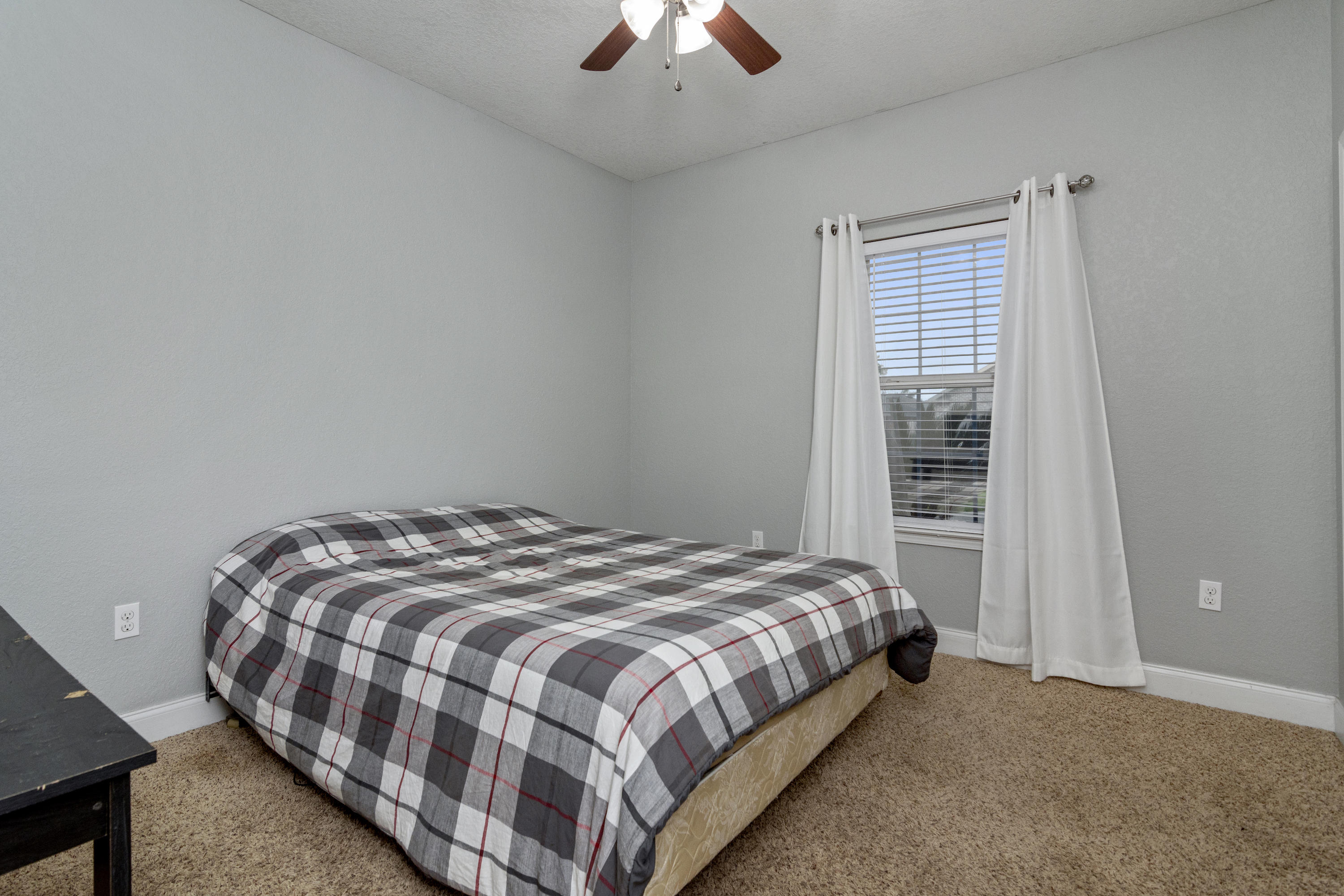 4610 Hermosa Road Crestview, FL 32539 - Photo 25 of 35 a bedroom with a bed and a chandelier