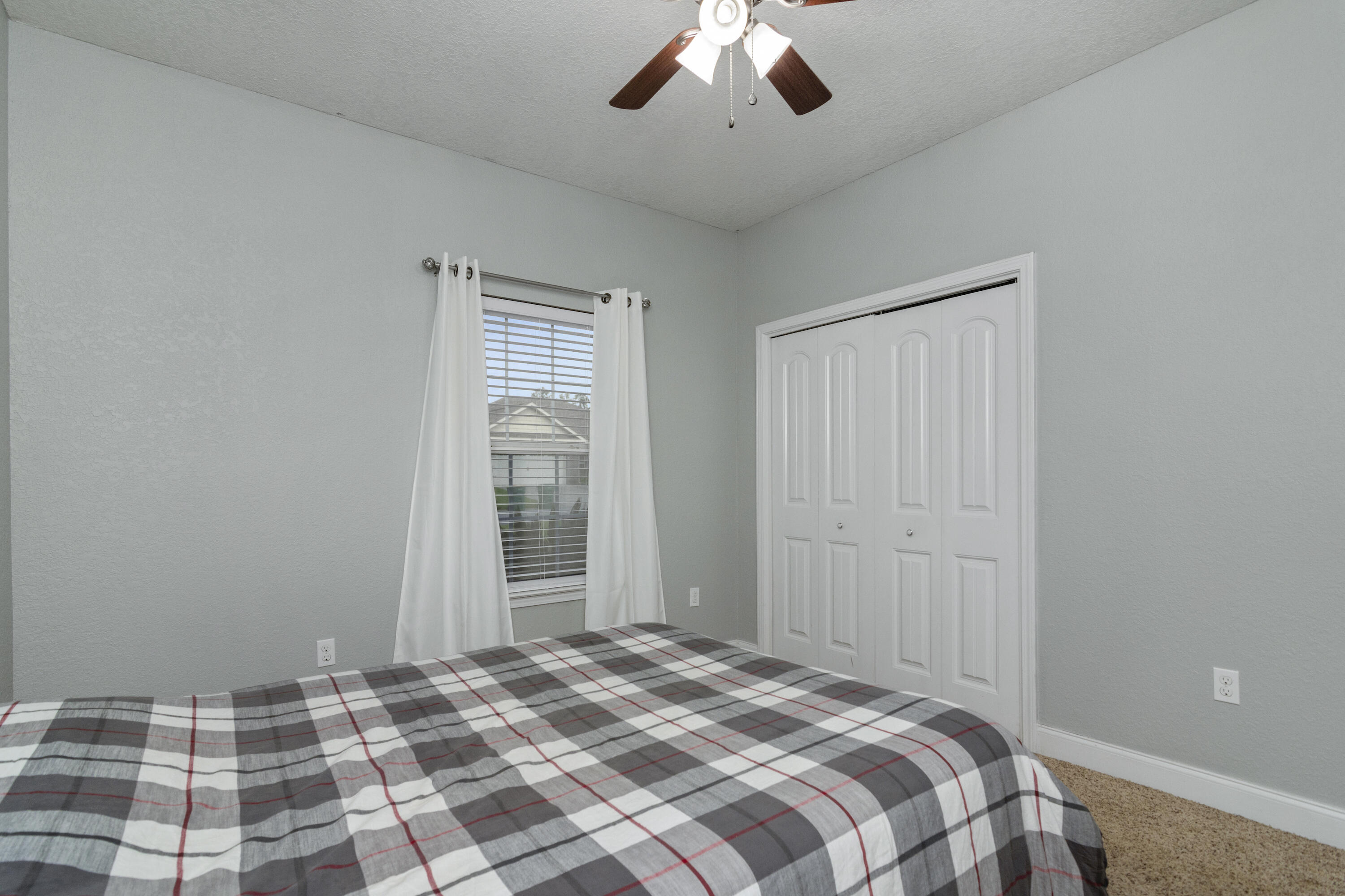 4610 Hermosa Road Crestview, FL 32539 - Photo 26 of 35 a bedroom with a bed and a chandelier