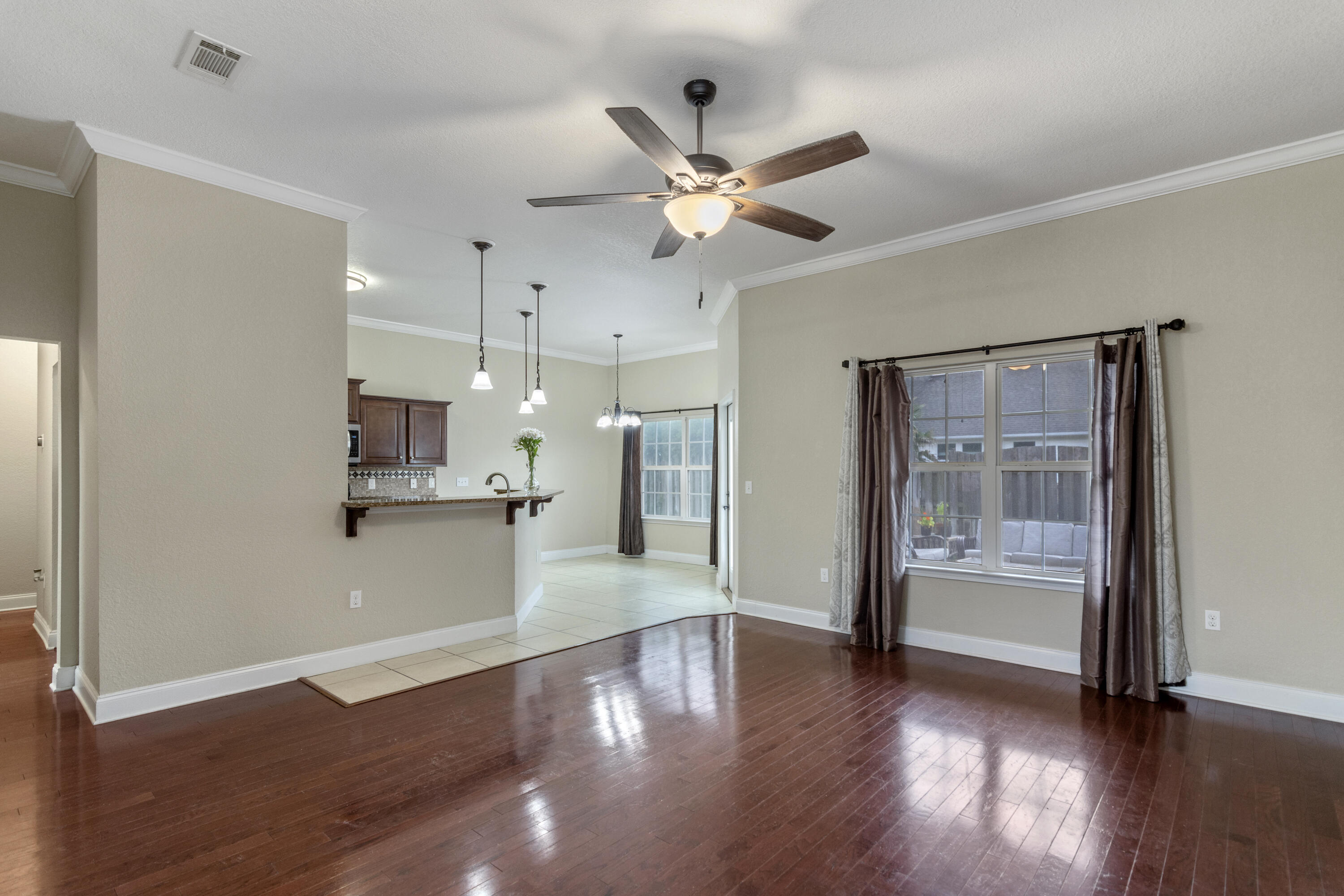 4610 Hermosa Road Crestview, FL 32539 - Photo 5 of 35 a view of a kitchen with wooden floor and a window