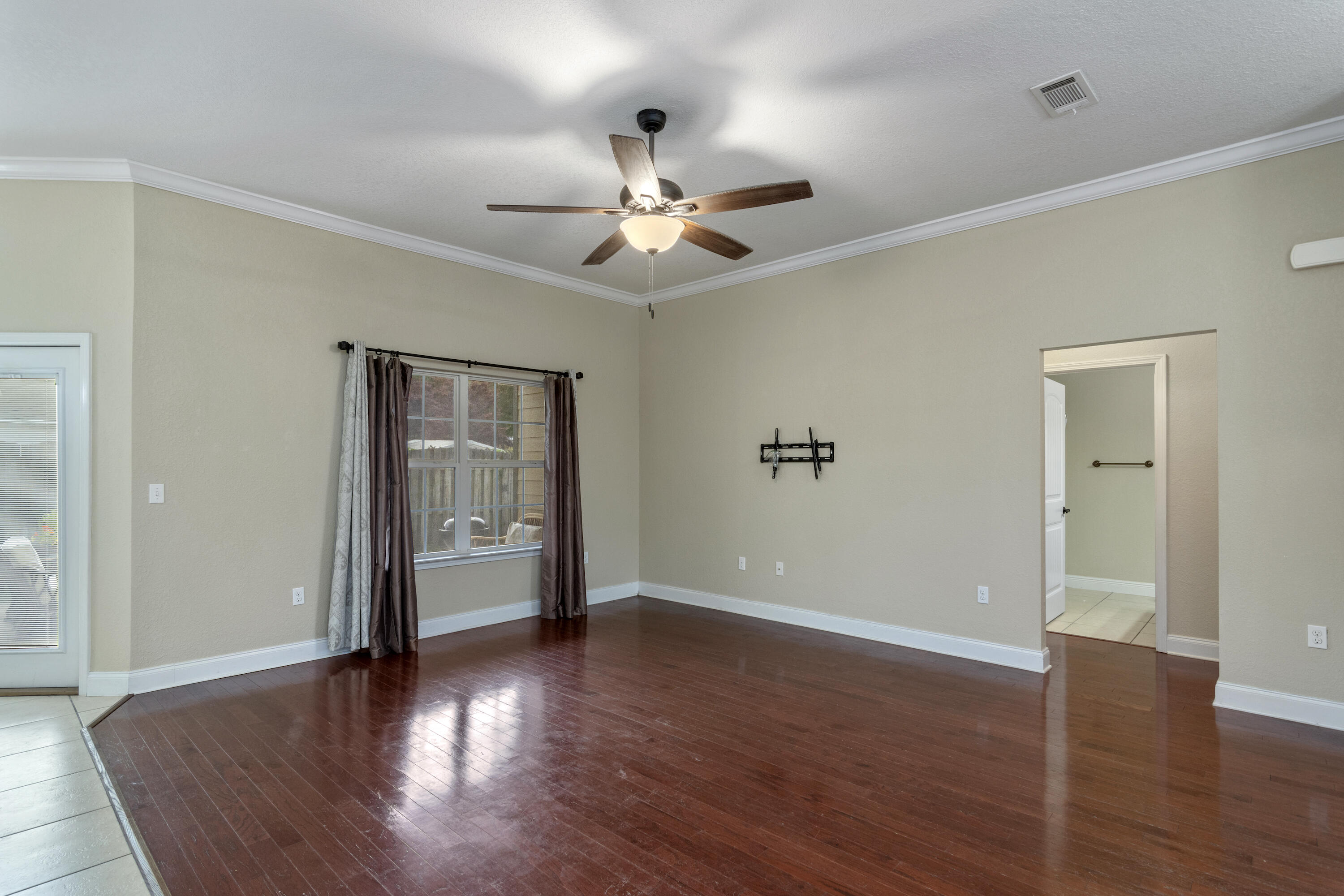 4610 Hermosa Road Crestview, FL 32539 - Photo 6 of 35 wooden floor in an empty room with a window