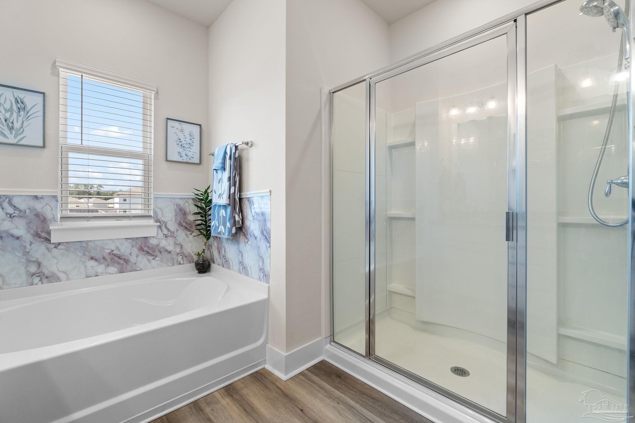 6060 Rutherford Loop Pensacola, FL 32526 - Photo 24 of 30 a bathroom with a bathtub and a shower