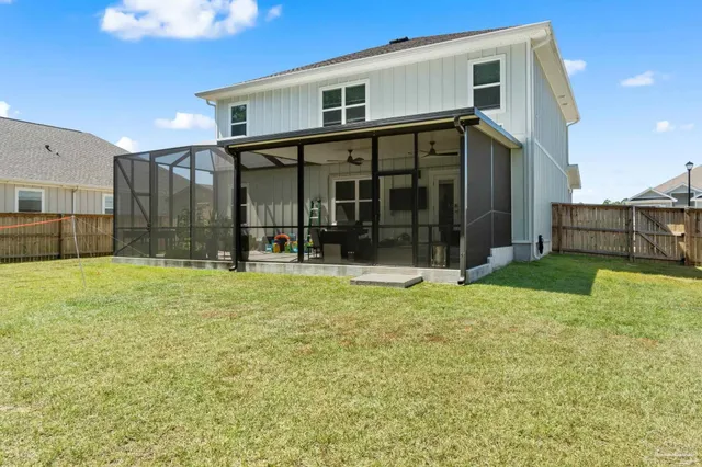 a view of a house with a backyard