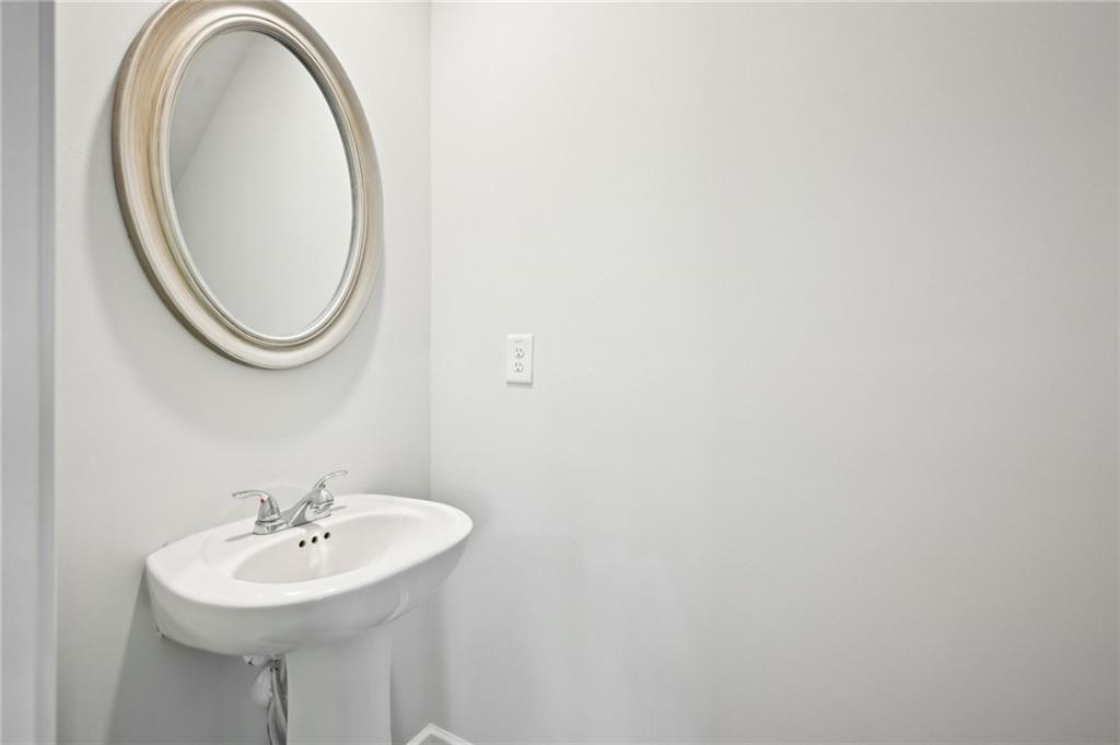 4437 Ben Hill Road Atlanta, GA 30349 - Photo 11 of 40 a bathroom with a sink and a mirror