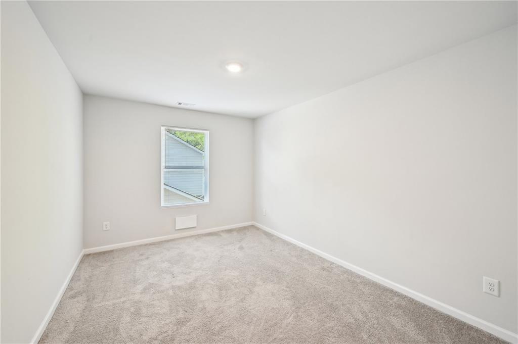 4437 Ben Hill Road Atlanta, GA 30349 - Photo 18 of 40 an empty room with a window
