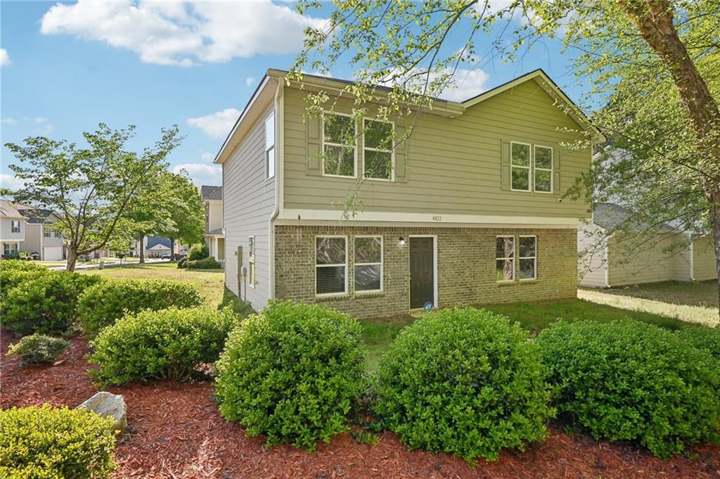 4437 Ben Hill Road Atlanta, GA 30349 - Photo 2 of 40 a front view of a house with a yard