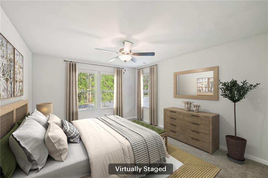 4437 Ben Hill Road Atlanta, GA 30349 - Photo 25 of 40 a bedroom with a bed and a chandelier