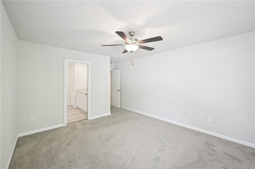 4437 Ben Hill Road Atlanta, GA 30349 - Photo 28 of 40 an empty room with a ceiling fan and a window