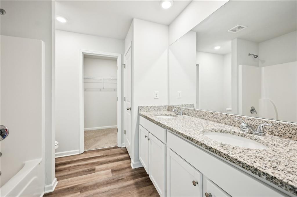 4437 Ben Hill Road Atlanta, GA 30349 - Photo 29 of 40 a bathroom with a granite countertop sink and a mirror