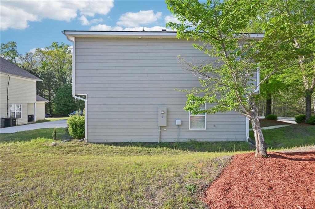 4437 Ben Hill Road Atlanta, GA 30349 - Photo 33 of 40 a view of a backyard with plants and large tree