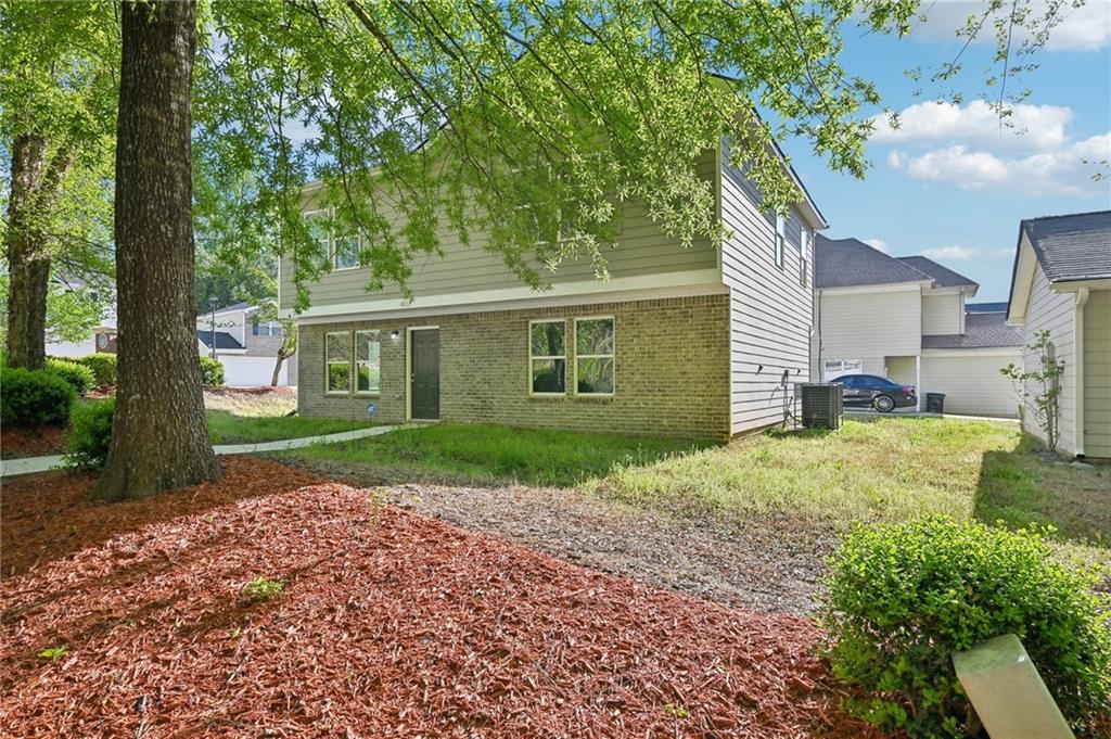 4437 Ben Hill Road Atlanta, GA 30349 - Photo 36 of 40 a view of a front of a house with a yard