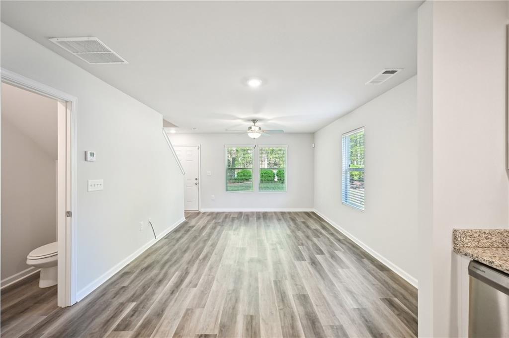 4437 Ben Hill Road Atlanta, GA 30349 - Photo 5 of 40 wooden floor in an empty room with a window