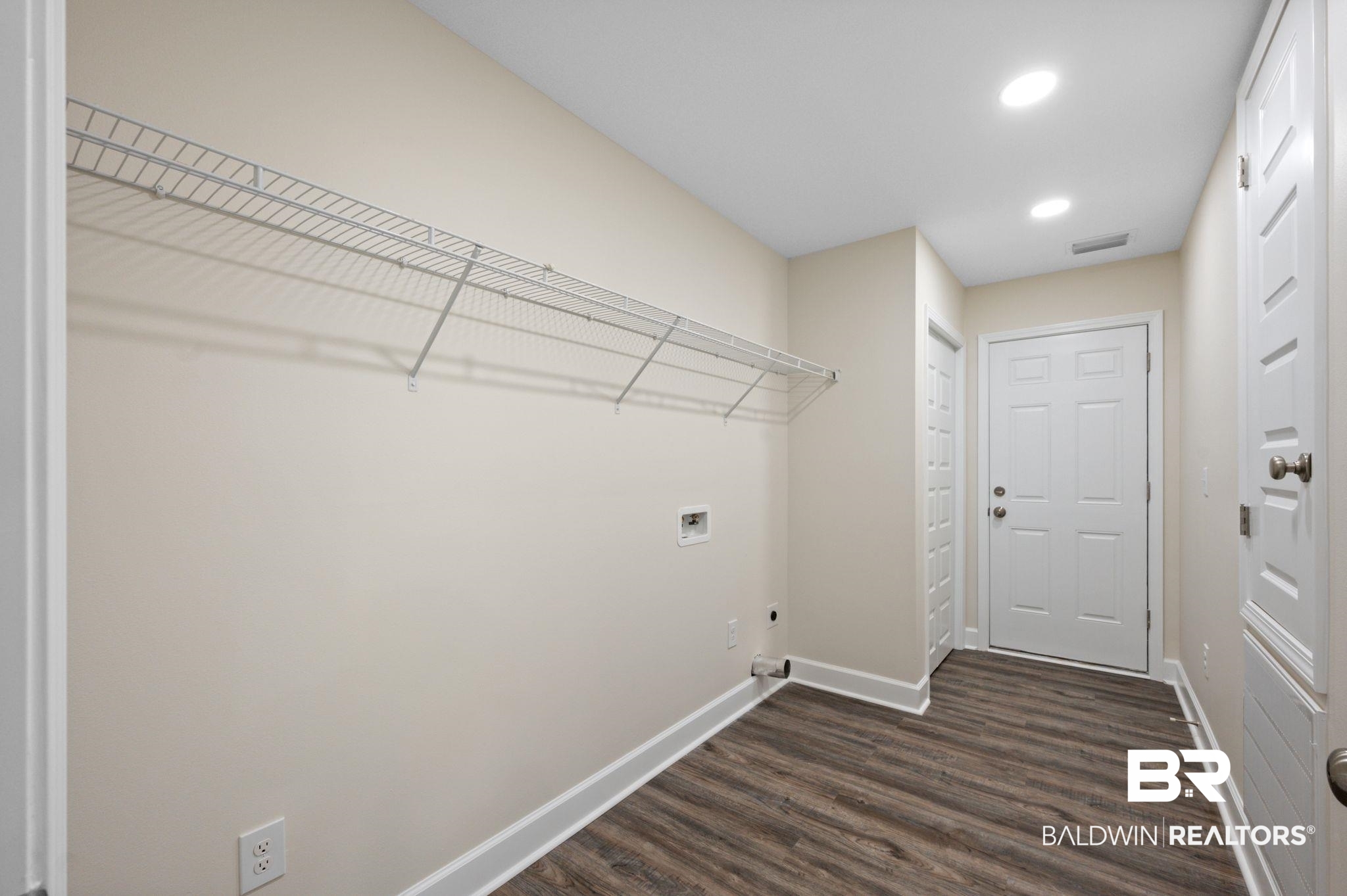 1473 Pollard Road Daphne, AL 36526 - Photo 29 of 32 Washroom featuring dark wood-type flooring, washer hookup, and hookup for an electric dryer
