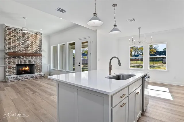 a view of kitchen with wooden floor and electronic appliances