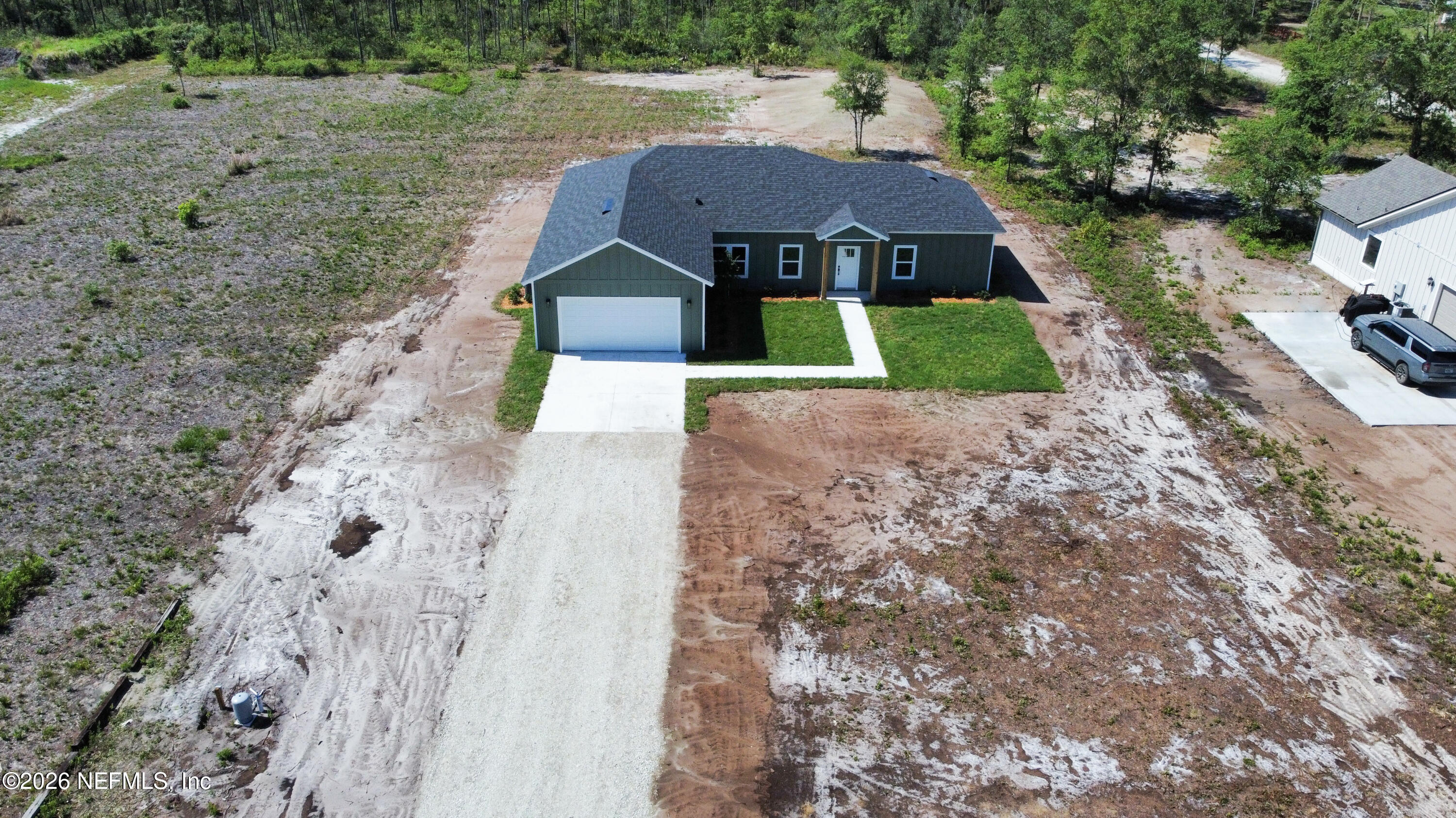 261121 Rowe Road Hilliard, FL 32046 - Photo 4 of 33 a aerial view of a house with yard and green space