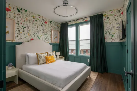 a bedroom with a bed and a window