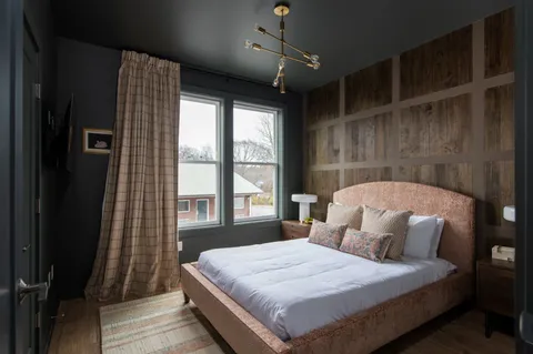 a bedroom with a large bed and a large window