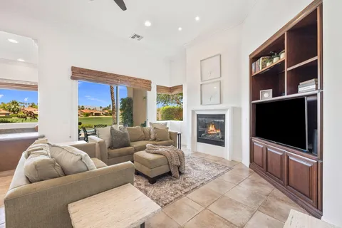 a living room with furniture and a dining table