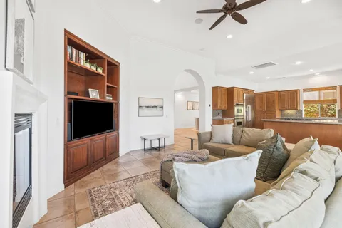 a dining room with furniture a large window and wooden floor