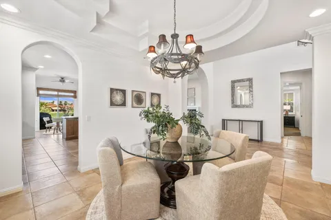 a kitchen with cabinets and chairs