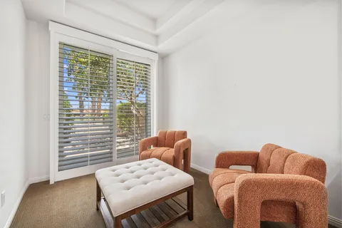 a bedroom with a bed and a mirror